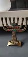 Menorah/Candlestick with 7 light arms. In old gold patinated brass/Decor 12 astrological signs. Engraved Jerusalem. Height 14 cm