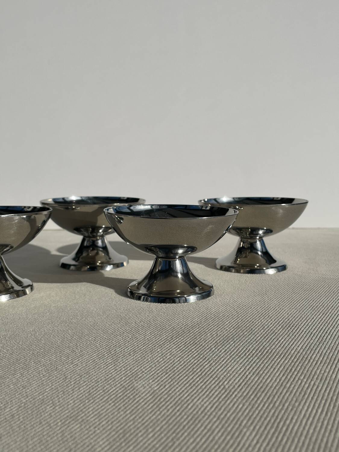 Set of 4 vintage metal ice cream glasses/cups on a stand.