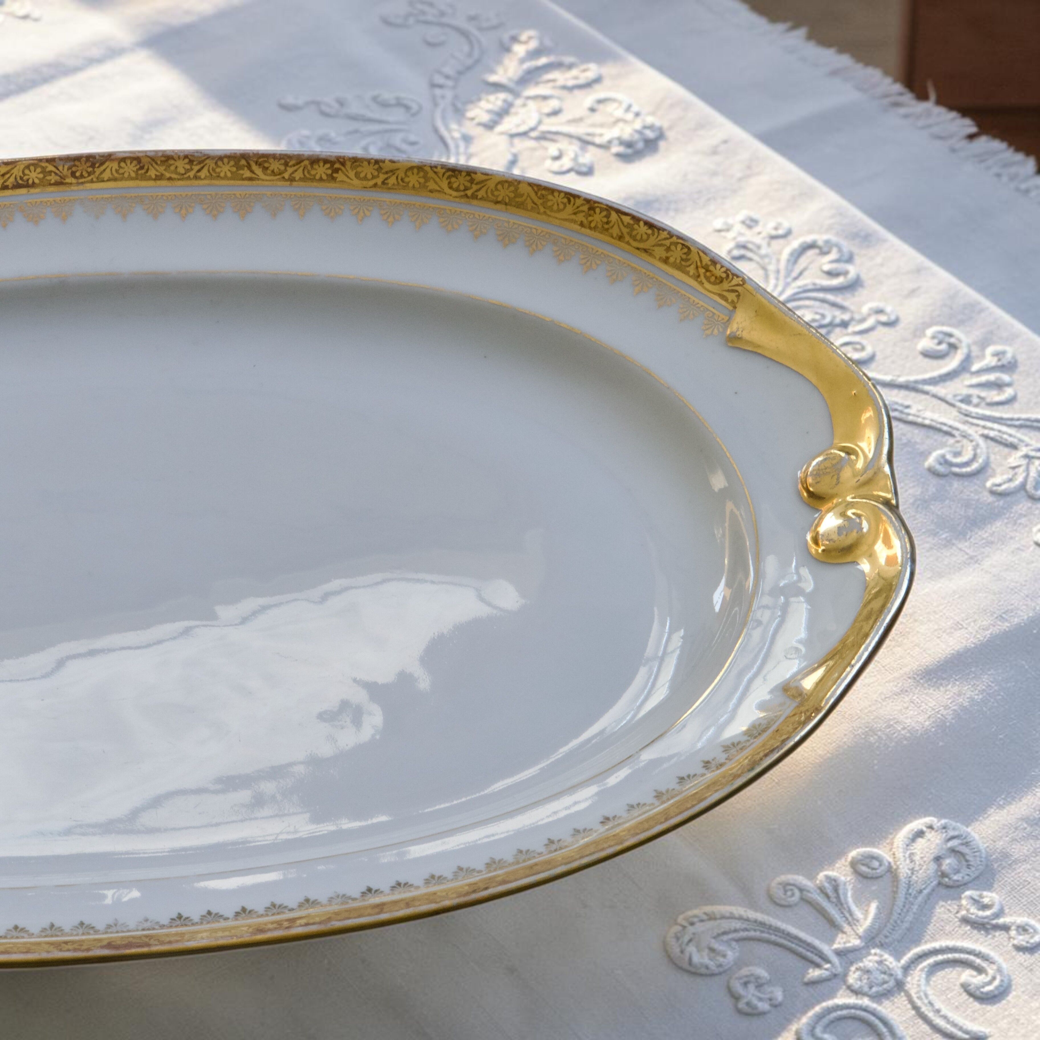 Large oval dish with gold trim in Limoges porcelain by Peconnet.