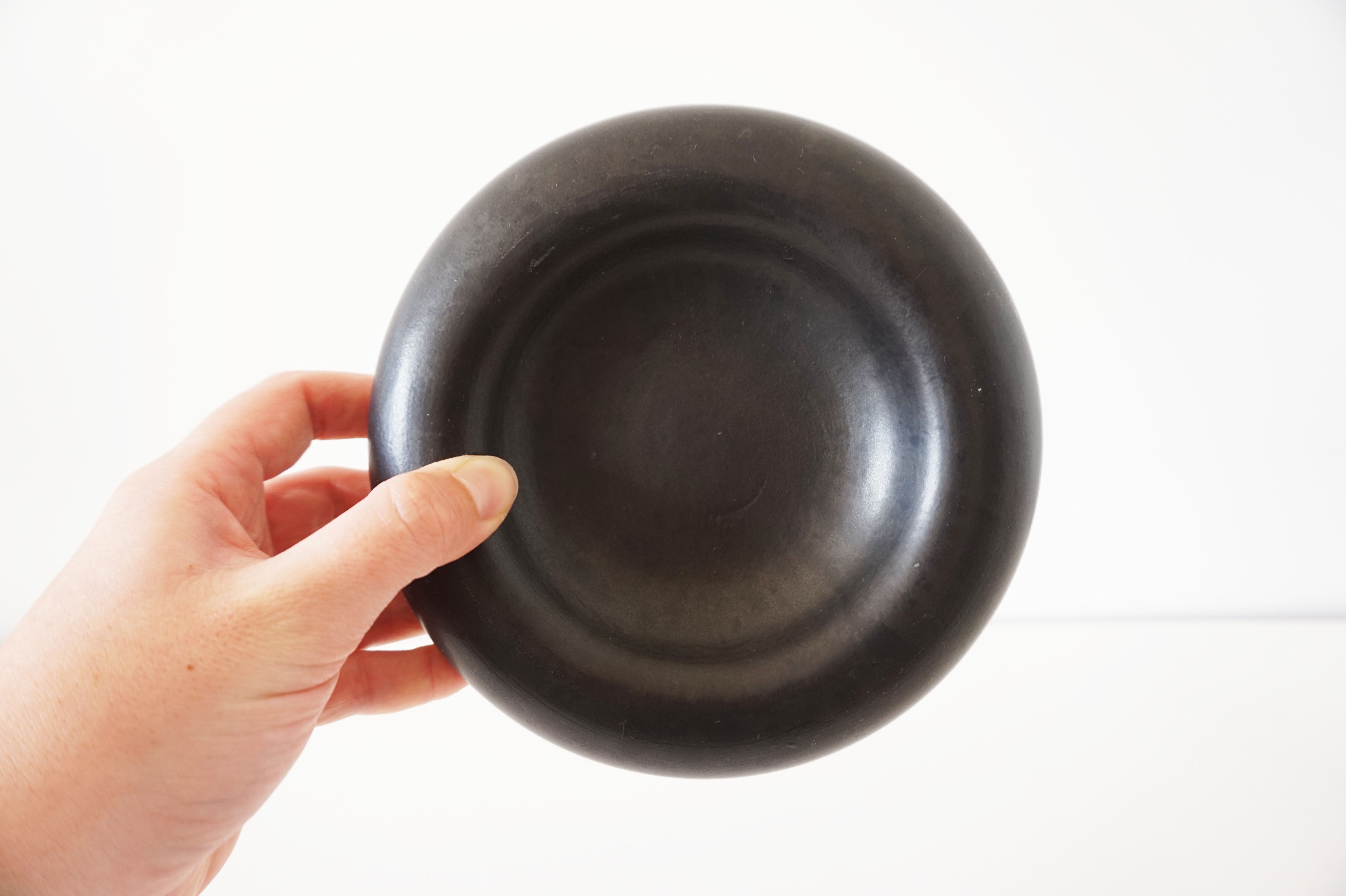 Empty round pocket in black ceramic