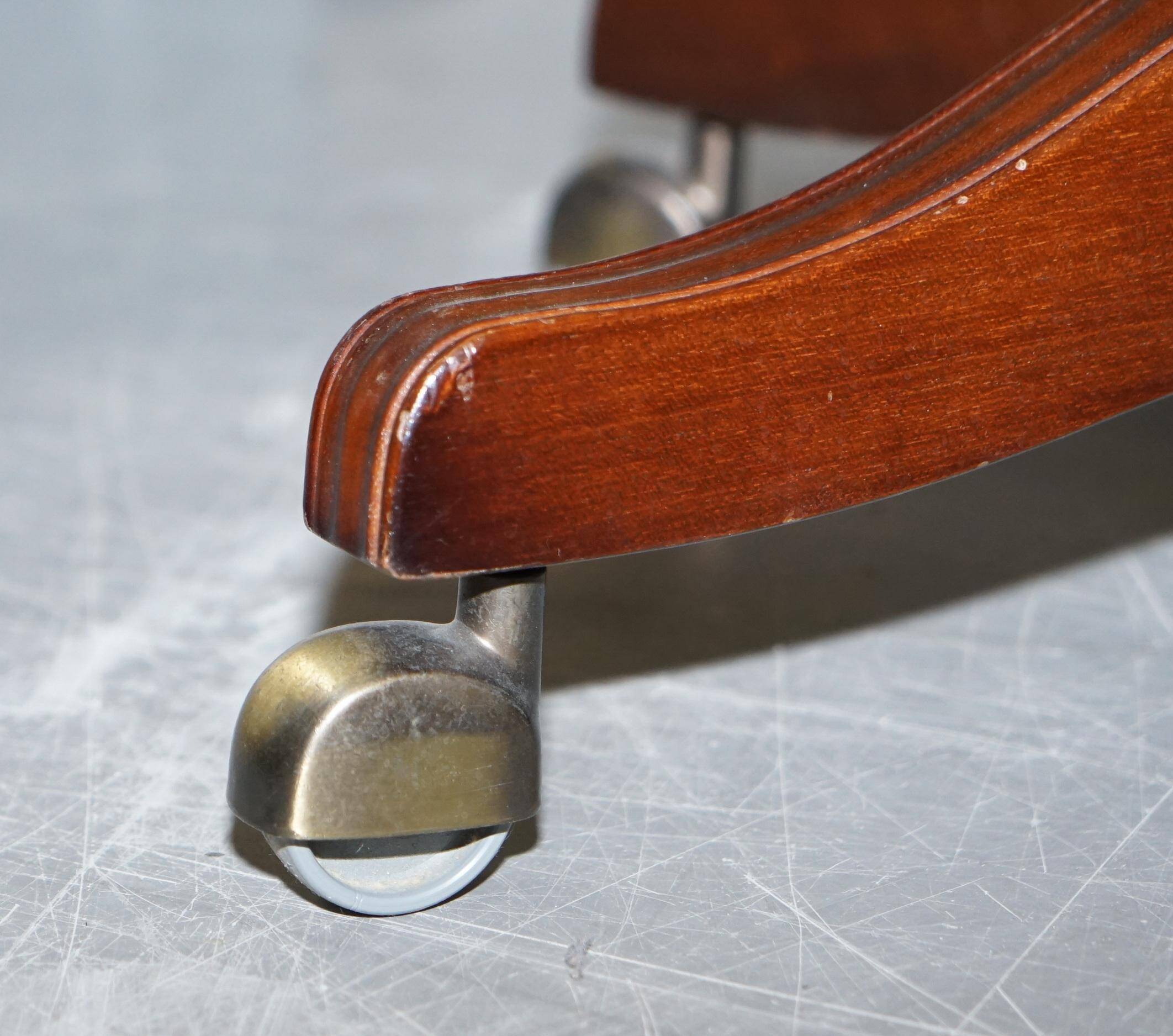 Chesterfield armchair in hardwood, leather, and woven linen.