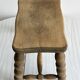 Antique wooden stool with four turned legs.