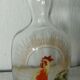 Glass carafe with enamel decoration featuring a rooster, late 19th century.