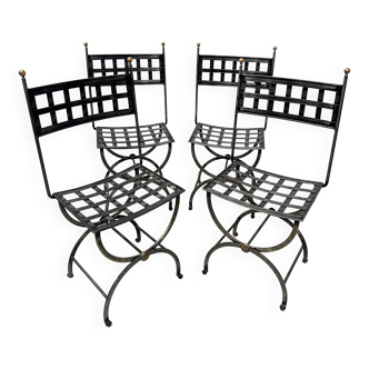 Set of four wrought iron chairs, with a reclining X-shaped base, seat and backrest.