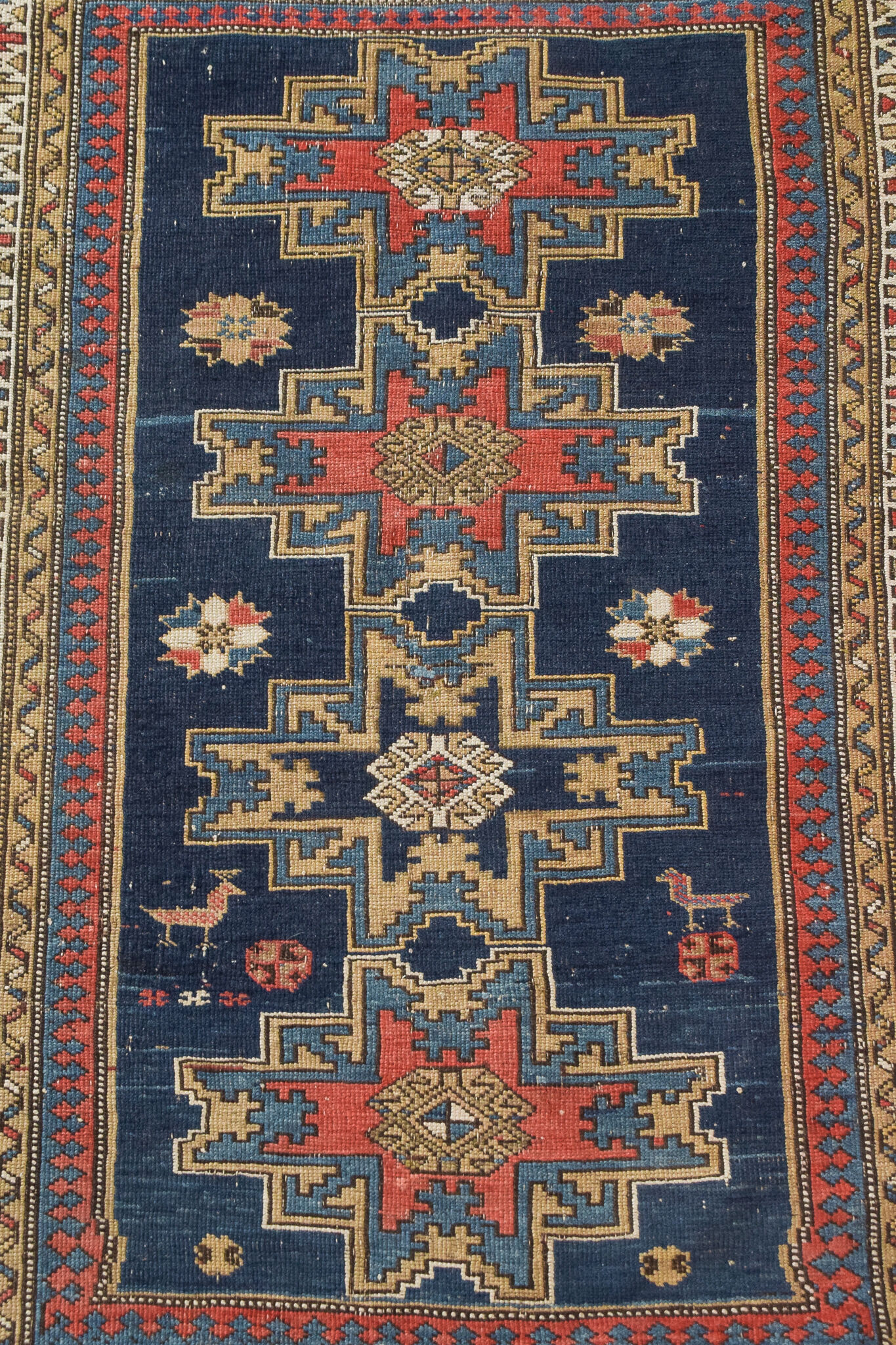 Handwoven blue ground persian rug with bird-like figures