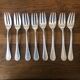 8 mismatched fish forks, silver metal