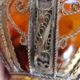 Small glass cup in metal frame