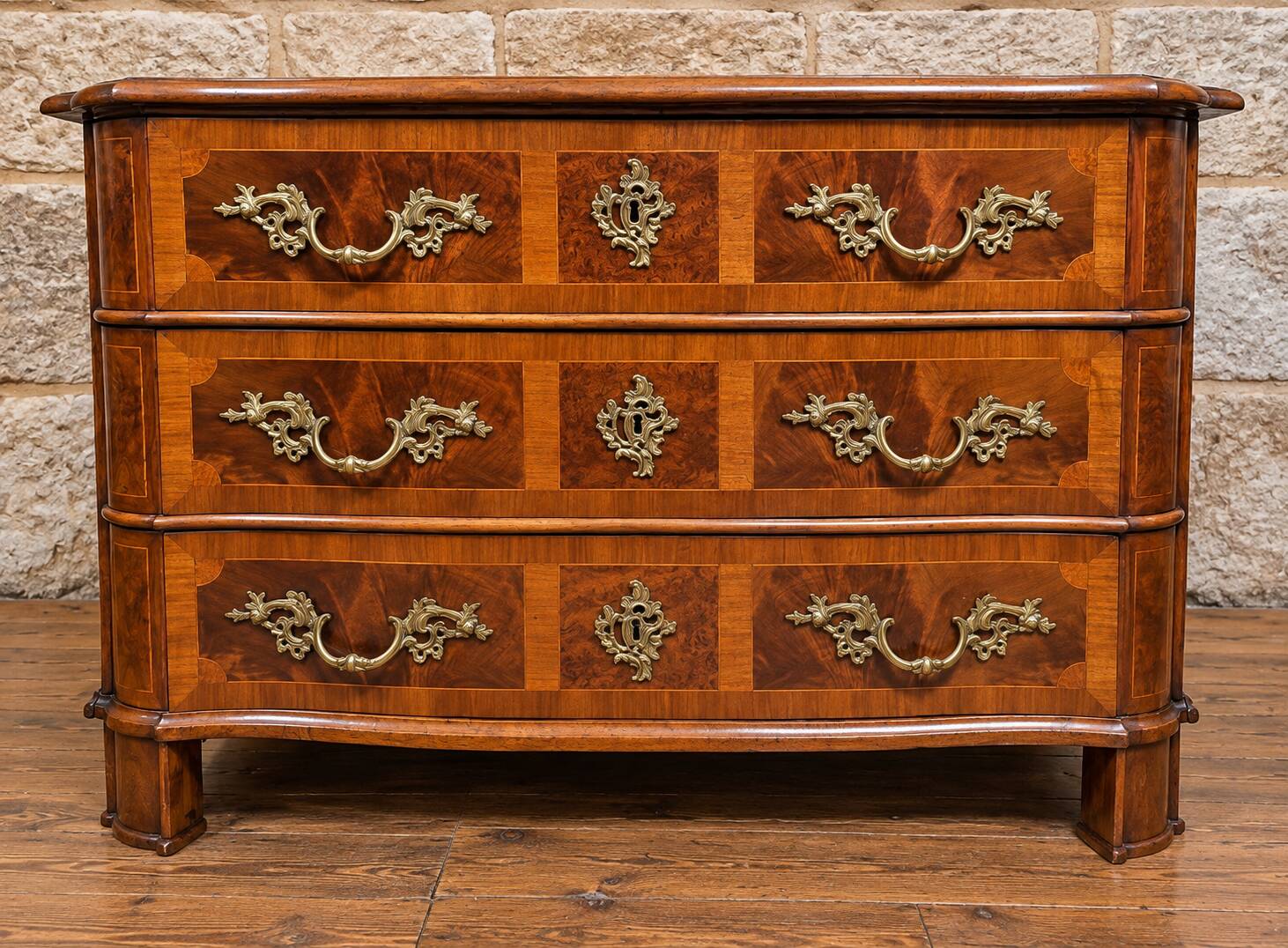 Curved commode from the Louis XIV period in marquetry - adorned with gilded bronze fittings.