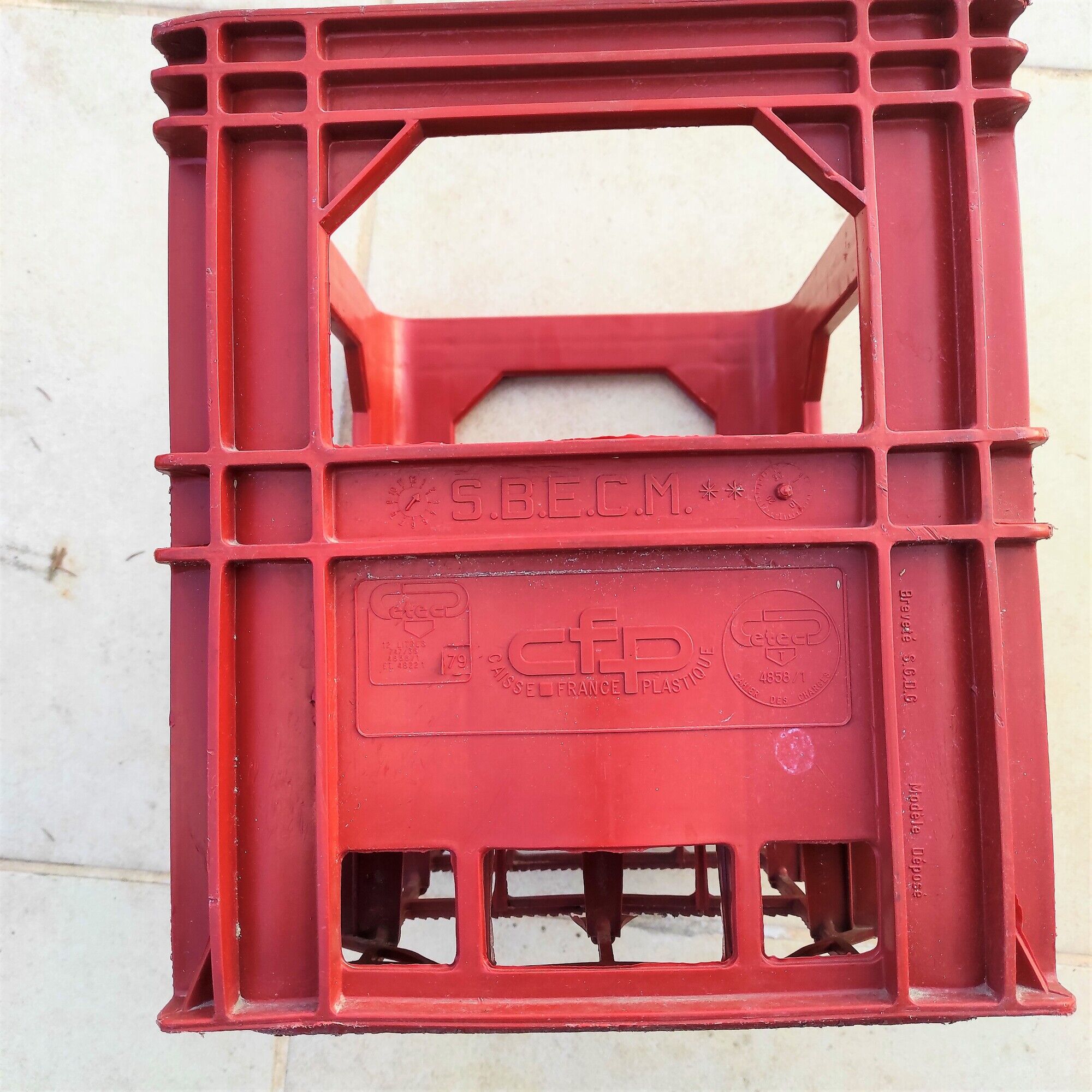 Locker with 12 red plastic bottles of the cfp brand around 1980