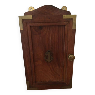Key box in wood and brass and central motif representing a sailor's anchor