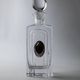 Vintage glass decanter from the 1980s, transparent glass with a silver plate and spherical stopper.
