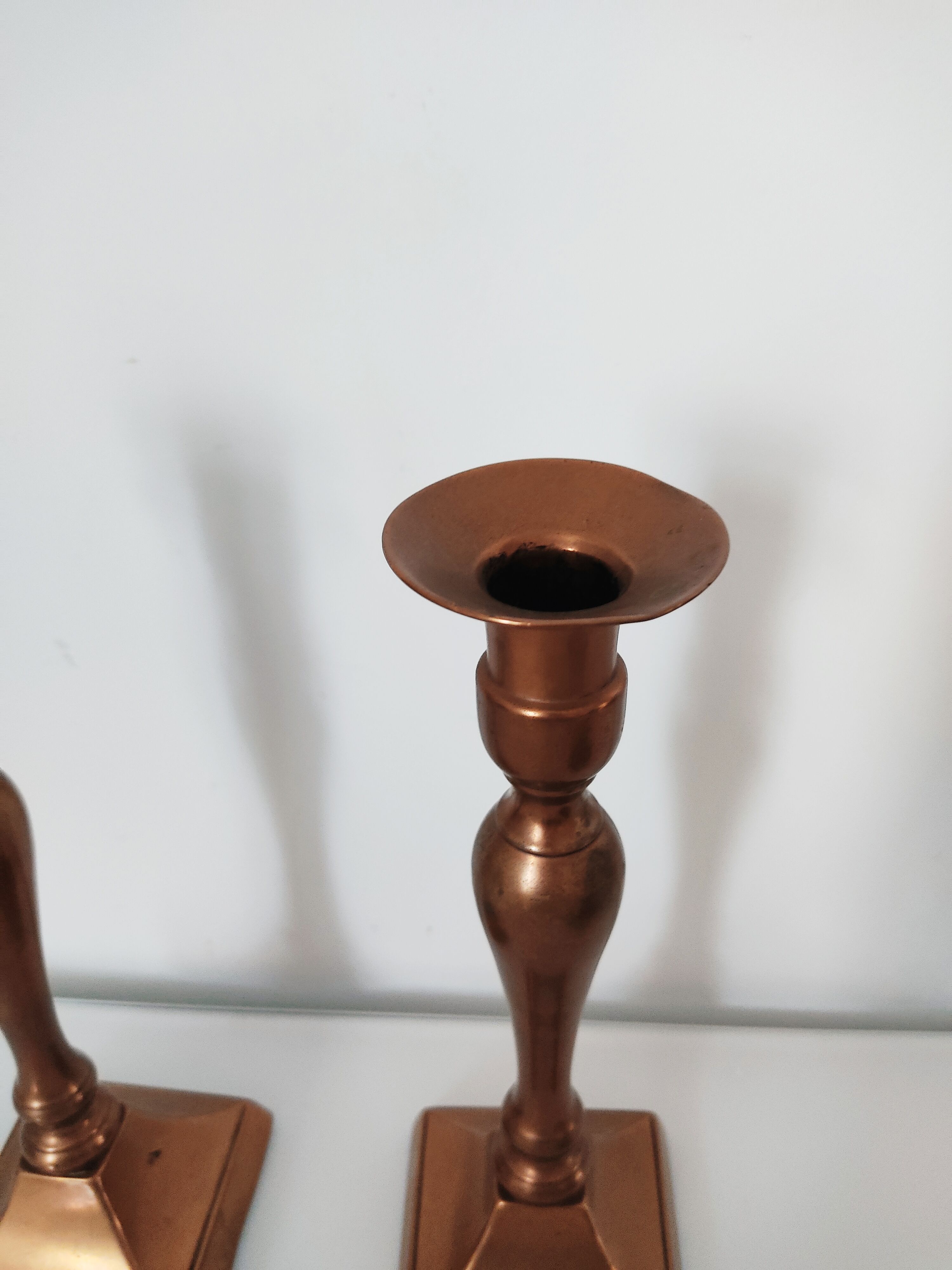 Set of a pair of candle holders and a hand candle holder