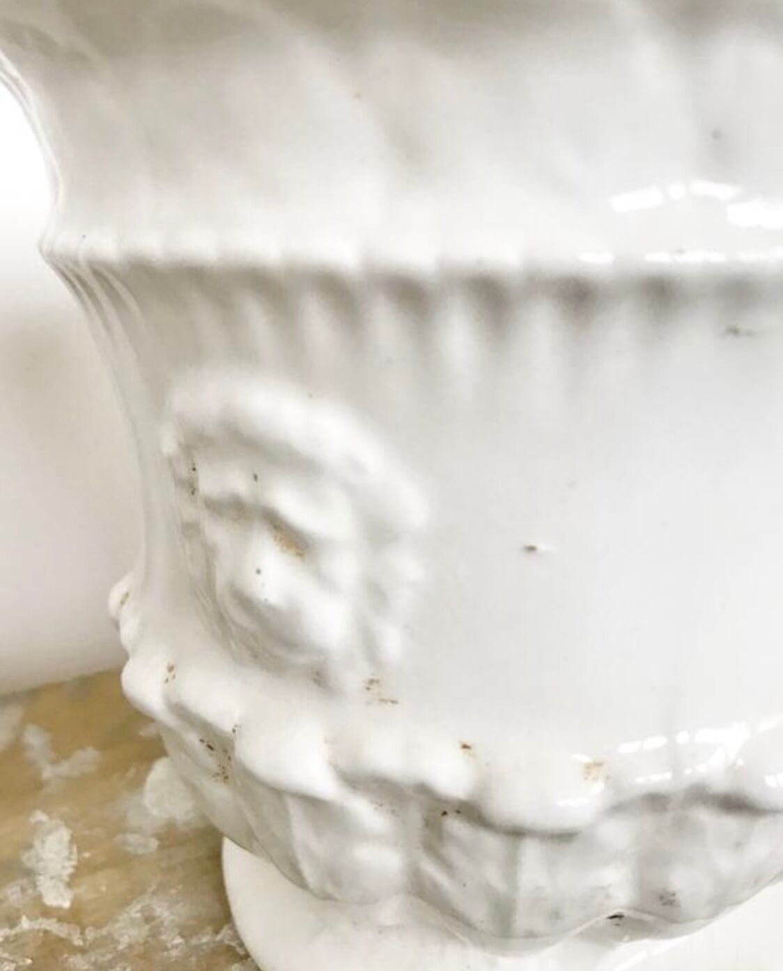 Vintage covered pot in white earthenware molded with lions and friezes