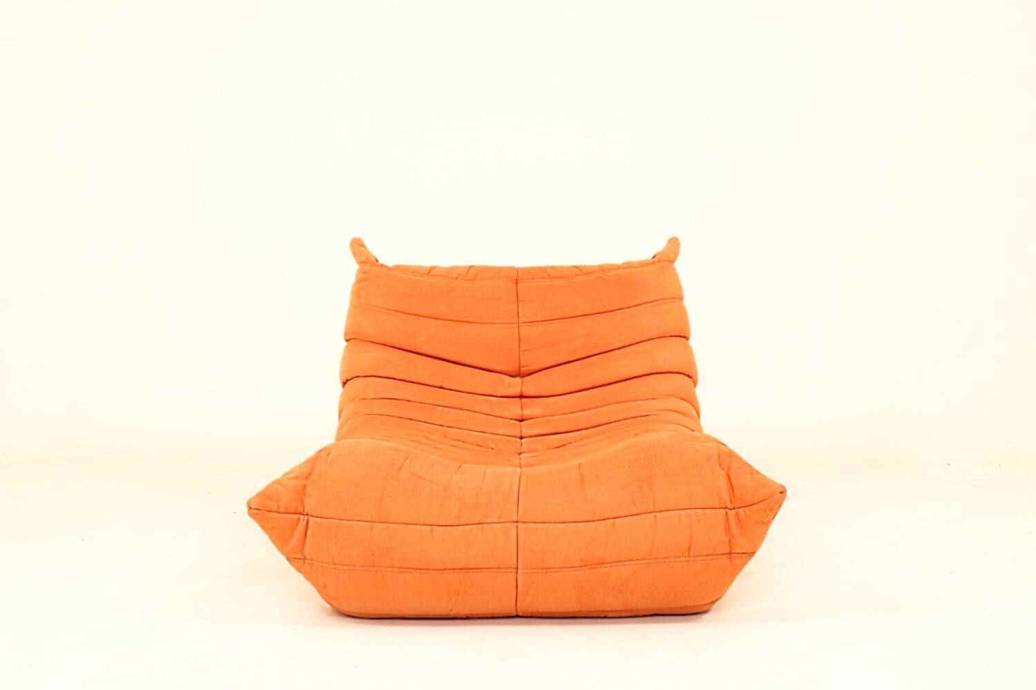 Togo sofa set and armchairs in pumpkin orange, 3 pieces, no label.