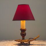 Vintage French bronze Wee Willie Winkie style lamp with red card shade.