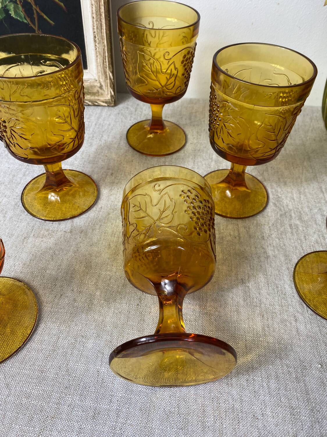 Six amber-colored stemmed glasses