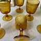Six amber-colored stemmed glasses