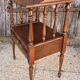 Solid wood bedside table with turned columns, early 20th century.
