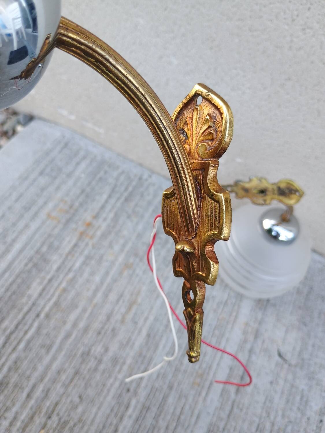 Pair of frosted glass wall lights with brass attachments, circa 1970