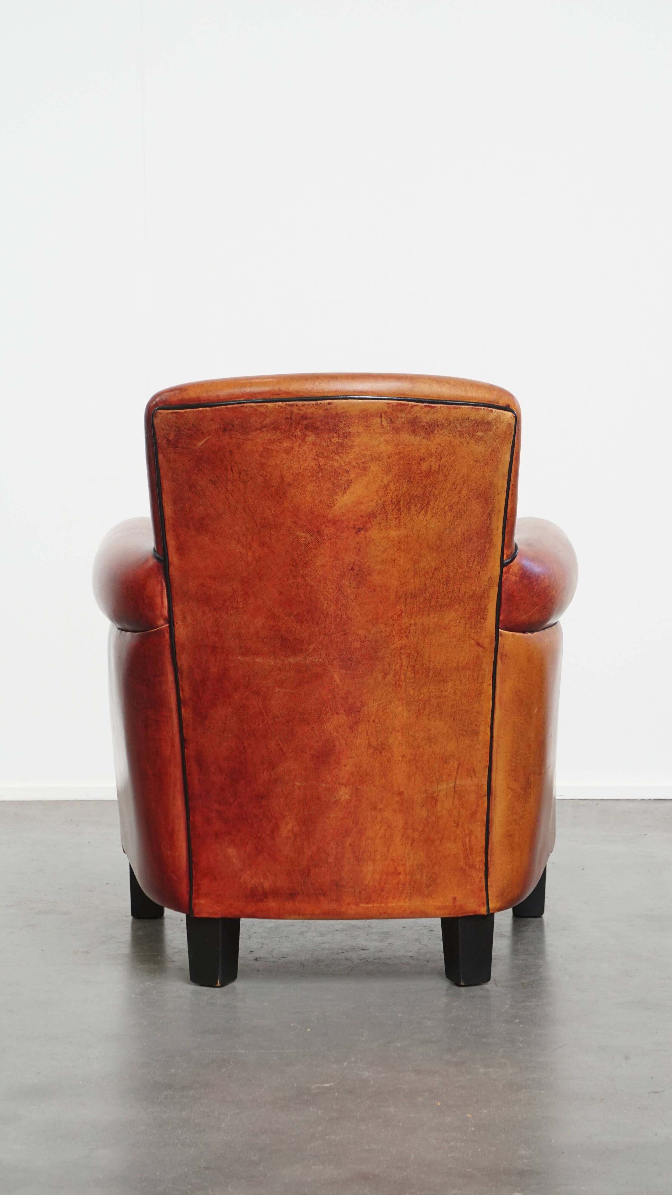 Armchair made of sheepskin leather in a red/brown color