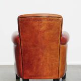 Armchair made of sheepskin leather in a red/brown color