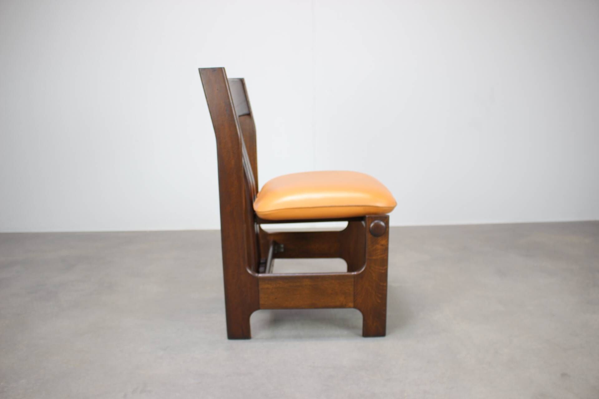 Vintage German sculptural chair from the 1970s in wood with orange faux leather.