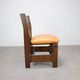 Vintage German sculptural chair from the 1970s in wood with orange faux leather.