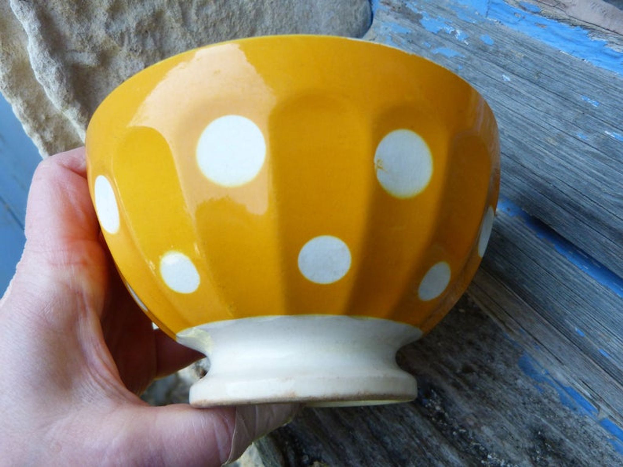 Old yellow ceramic coffee bowl with white polka dots