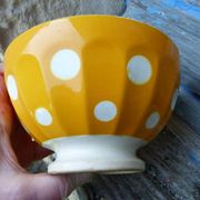 Old yellow ceramic coffee bowl with white polka dots