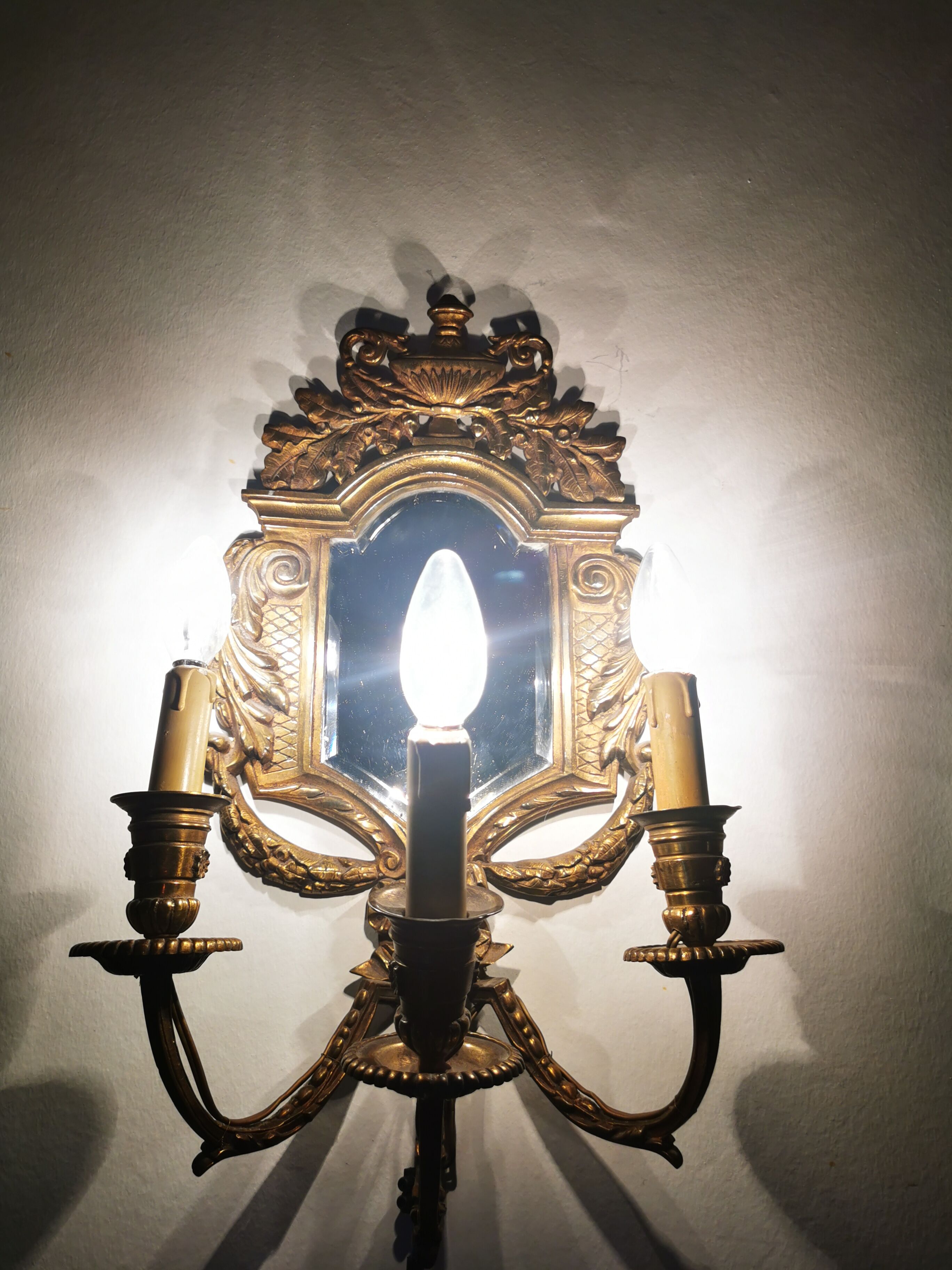 Pair of chissed and gilded bronze mirrors forming appliques