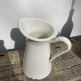 Old white enamelled metal pitcher