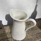 Old white enamelled metal pitcher