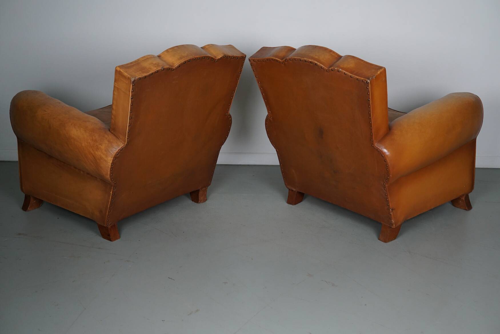 Pair of French Cognac Moustache Back Leather Club Chairs, 1950s