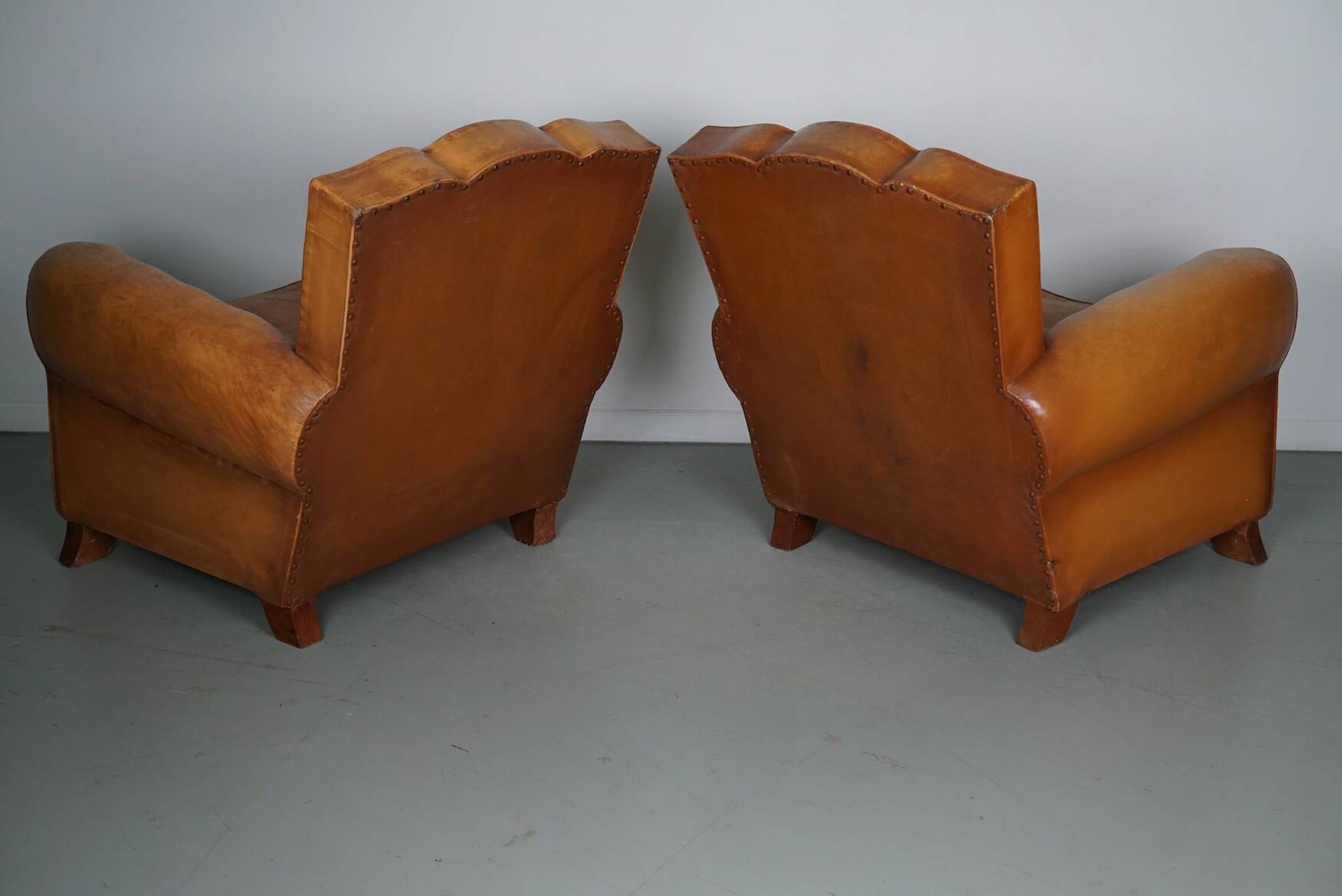 Pair of French Cognac Moustache Back Leather Club Chairs, 1950s