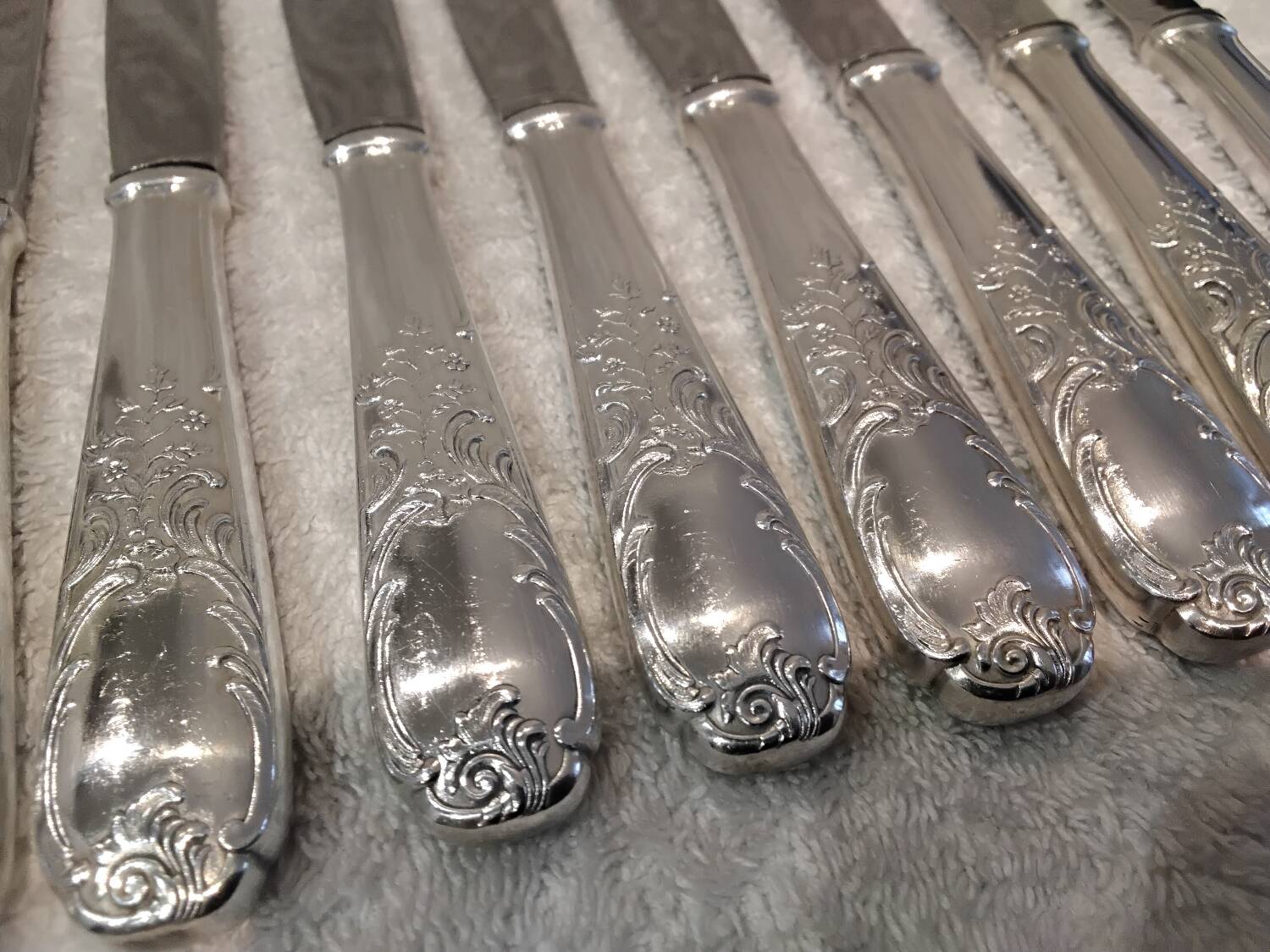 12 silver-plated dessert knives by Platil, rocaille style