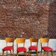 Set of 4 vintage bistro chairs in wood and red faux leather, with splayed legs.