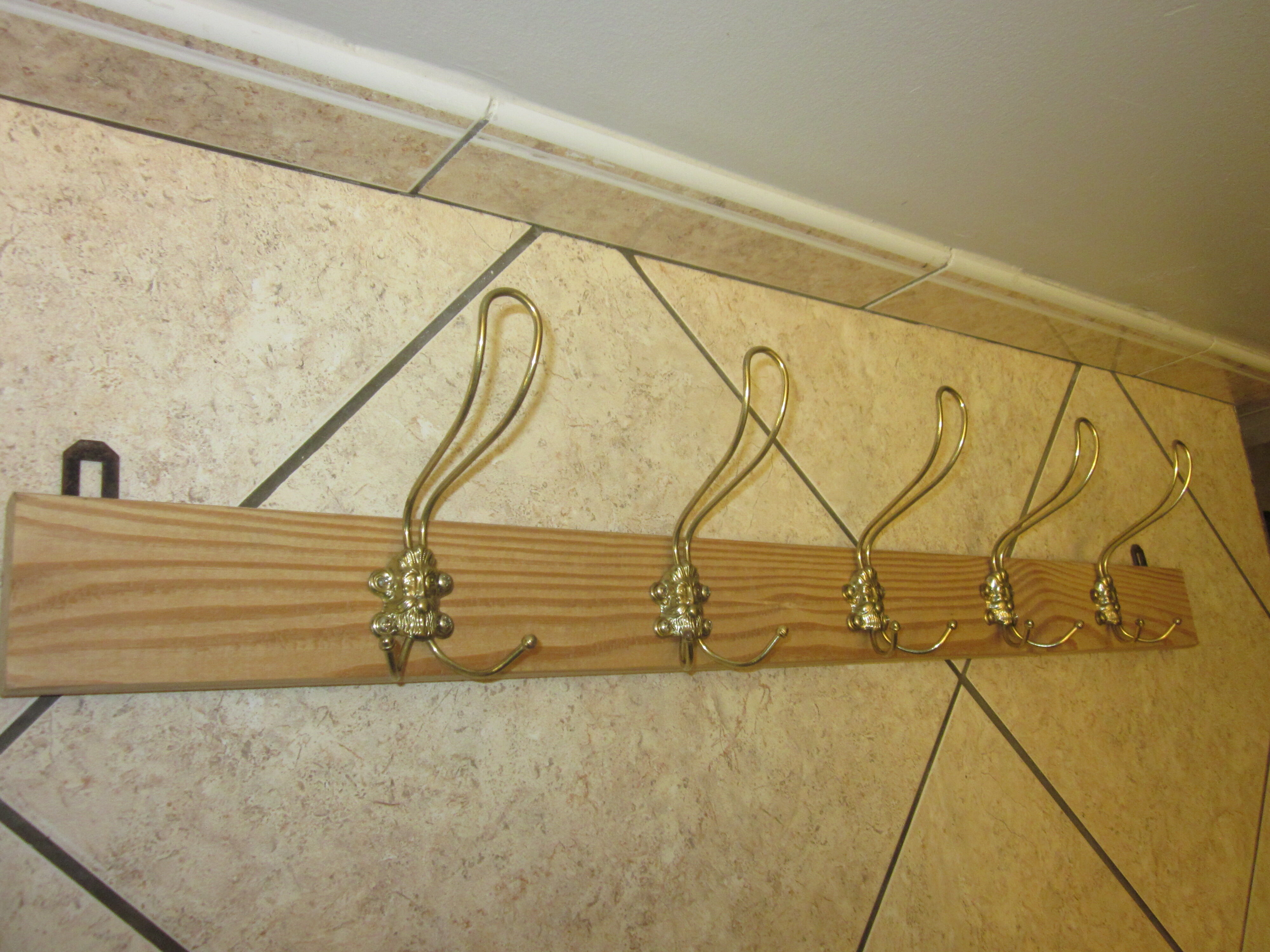 old coat rack with 5 metal hooks