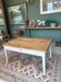 Coffee table with sandblasted top and painted legs.