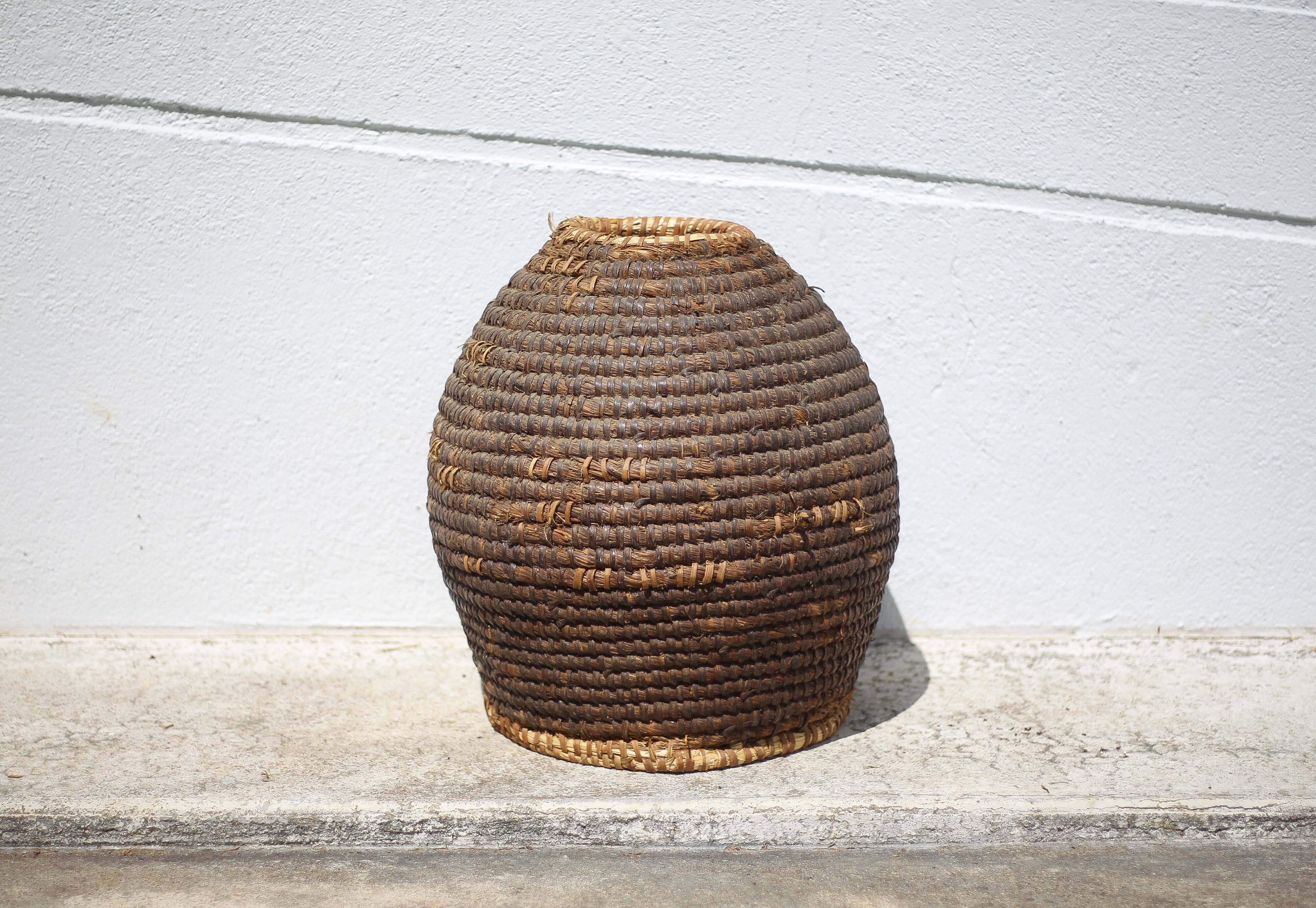 Old basket, burgundy straw and bramble, woven basket, interior decoration, pantry, flowerpot