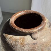 Large traditional Indonesian clay pot featuring a dragon.