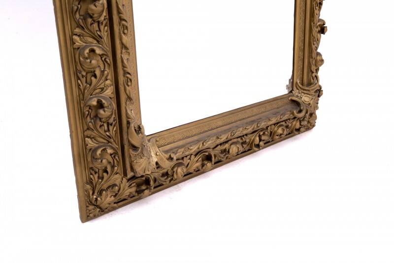 Antique mirror in richly decorated frame, France.