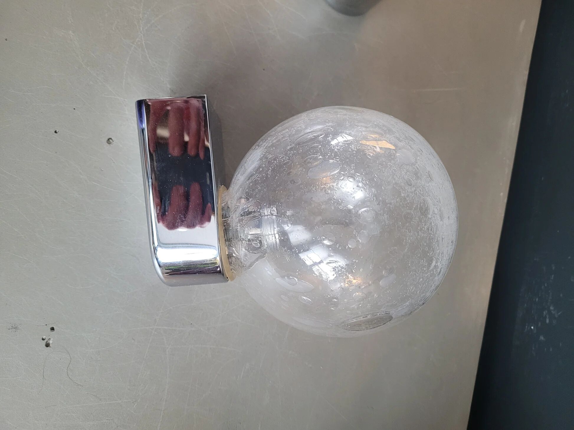 Pair of vintage wall lights in chrome metal with bubbled glass globes.