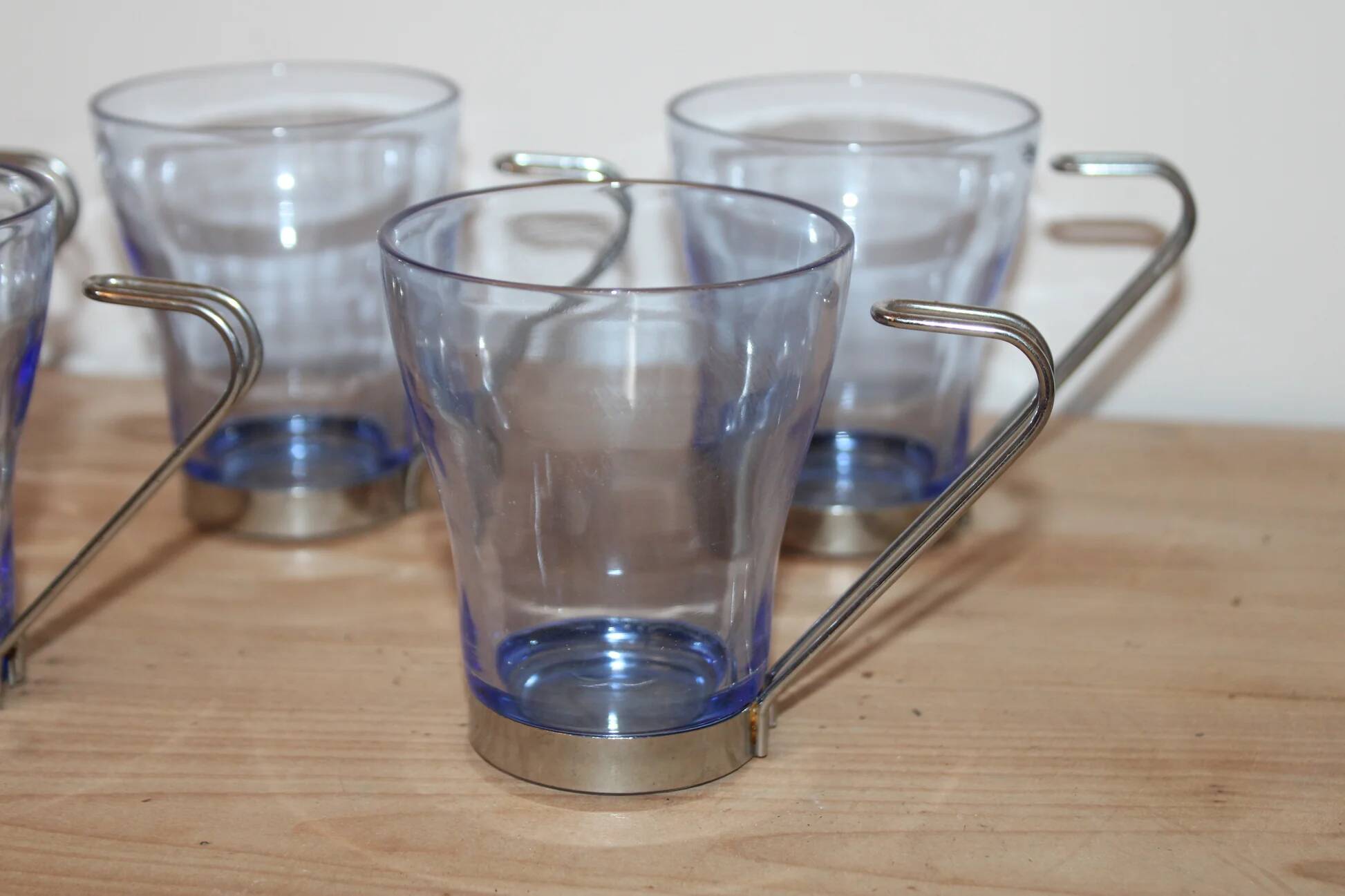 Set of 5 vintage blue-tinted glass cups with metal holders.