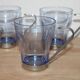 Set of 5 vintage blue-tinted glass cups with metal holders.