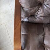 1970s Scandinavian armchair in curved laminated wood with a leather seat.