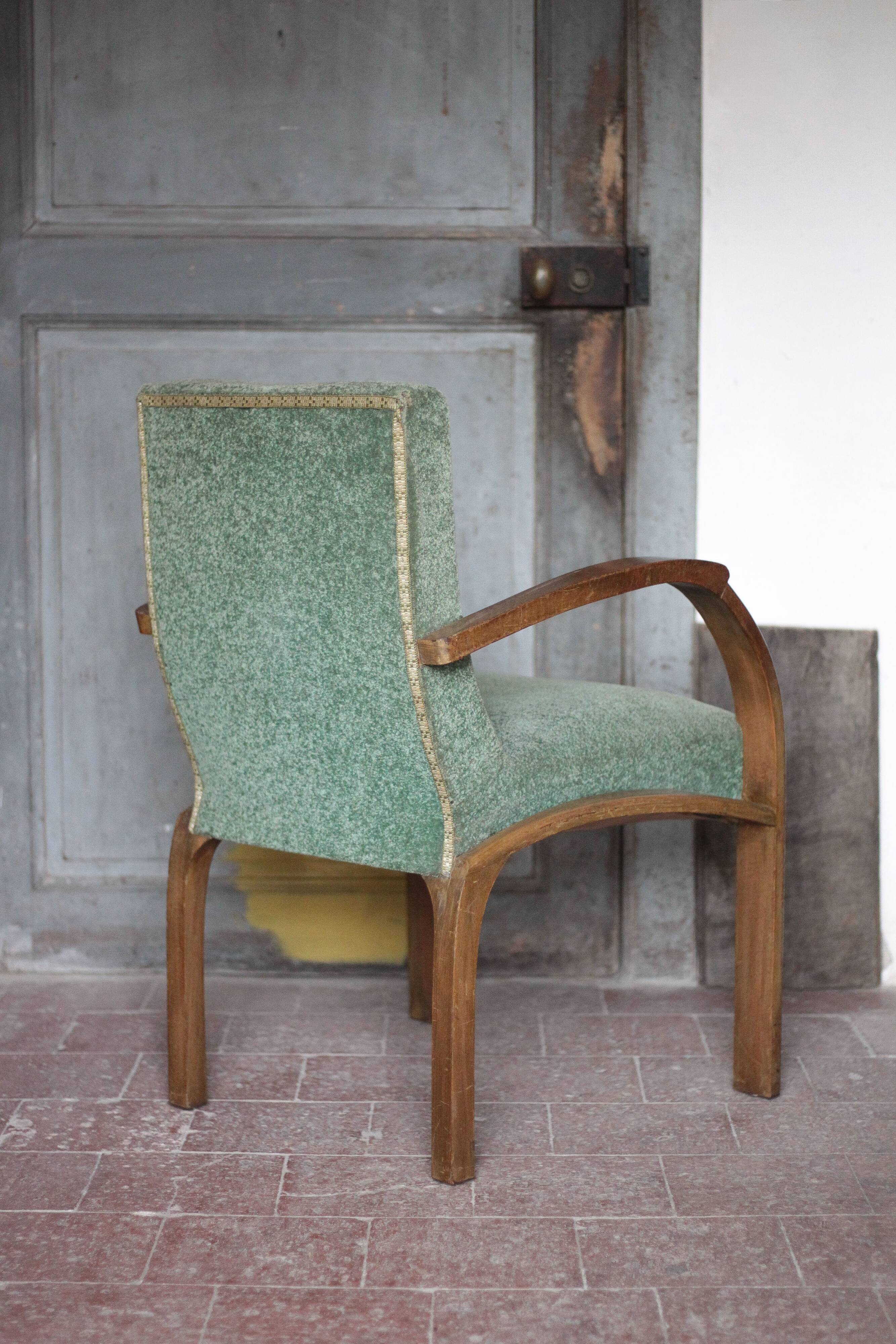 Art Deco armchair in wood and green fabric, living room armchair, interior decor.