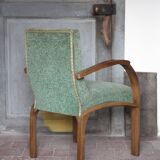 Art Deco armchair in wood and green fabric, living room armchair, interior decor.