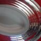 Oval plate in silver metal. pearl entourage. signed.