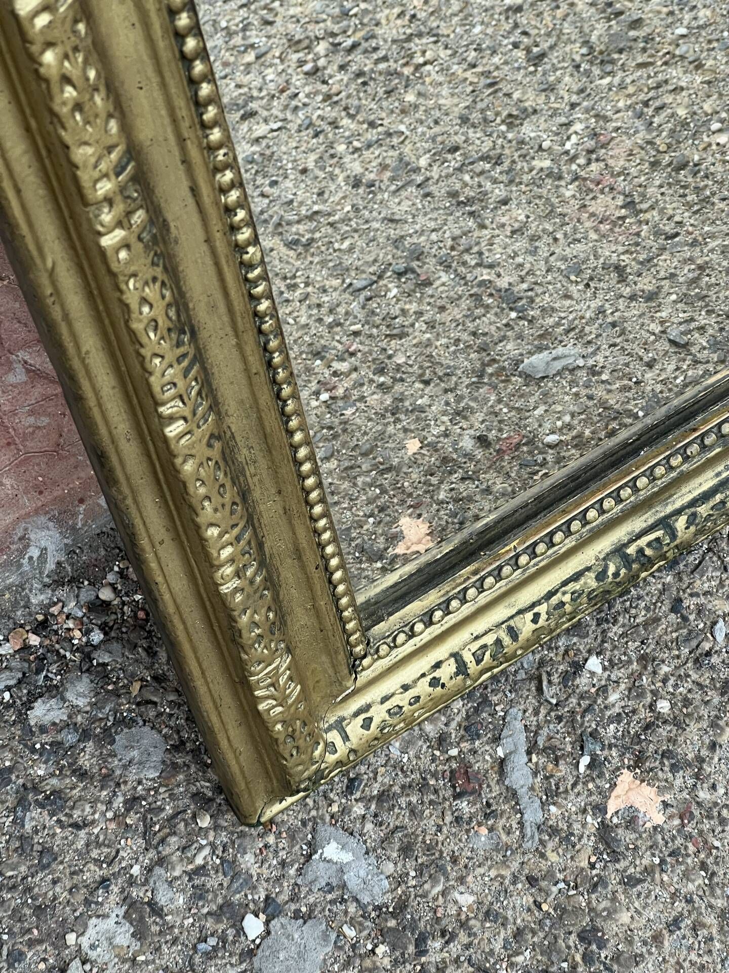 Louis Philippe mirror in gilded wood with an openwork frieze.