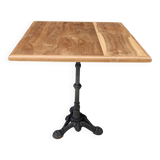 Bistro table with cast iron base and teak top